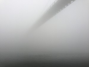 The St. Johns Bridge disappears over the Willamette River into the fog